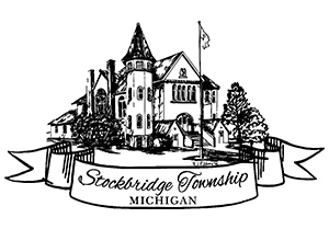 Logo for Stockbridge Township, Michigan. An illustrated town hall sits above an illustrated banner with the text "Stockbridge Township Michigan" on it.
